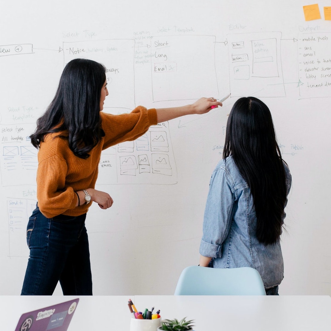 women in front of whiteboard